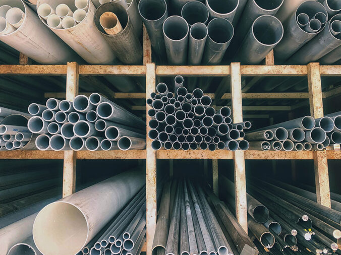 PVC pipes stacked in a plumbing supply warehouse