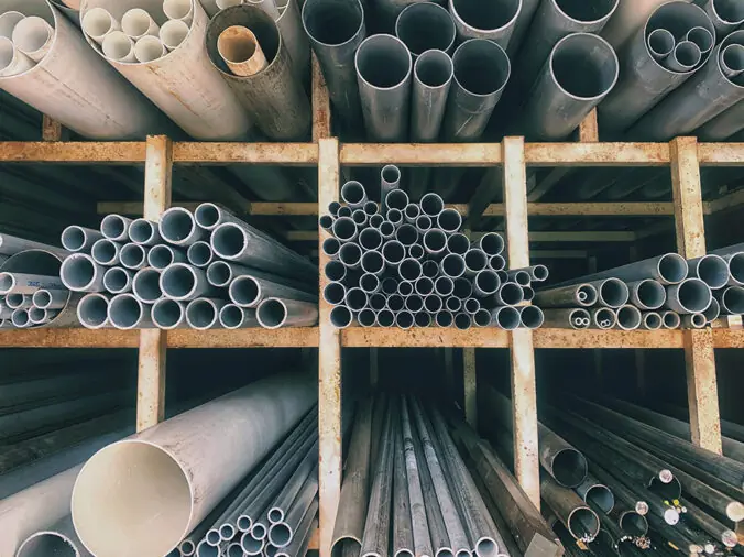 PVC pipes stacked in a plumbing supply warehouse