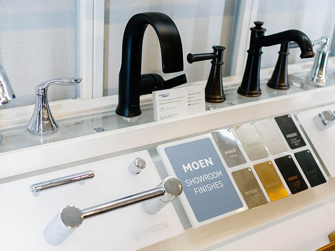 Black Moen faucet and finish samples at the Hughes Greenville Kitchen & Bath Showroom