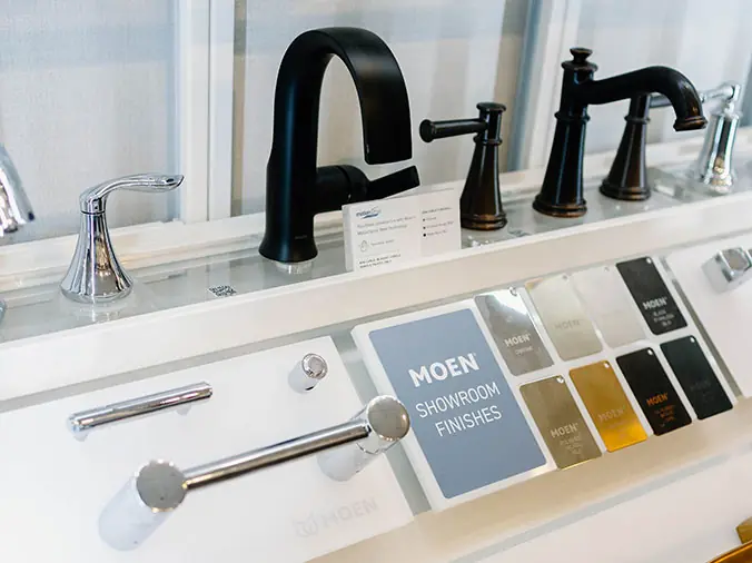 Black Moen faucet and finish samples at the Hughes Greenville Kitchen & Bath Showroom