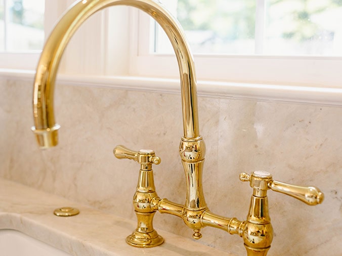 Polished brass gooseneck kitchen sink faucet